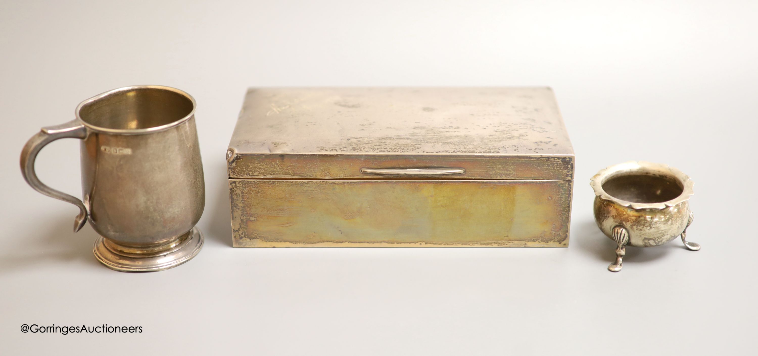 A George V silver rectangular cigarette box, Birmingham, 1926,16.5cm, a silver christening mug and a silver salt.